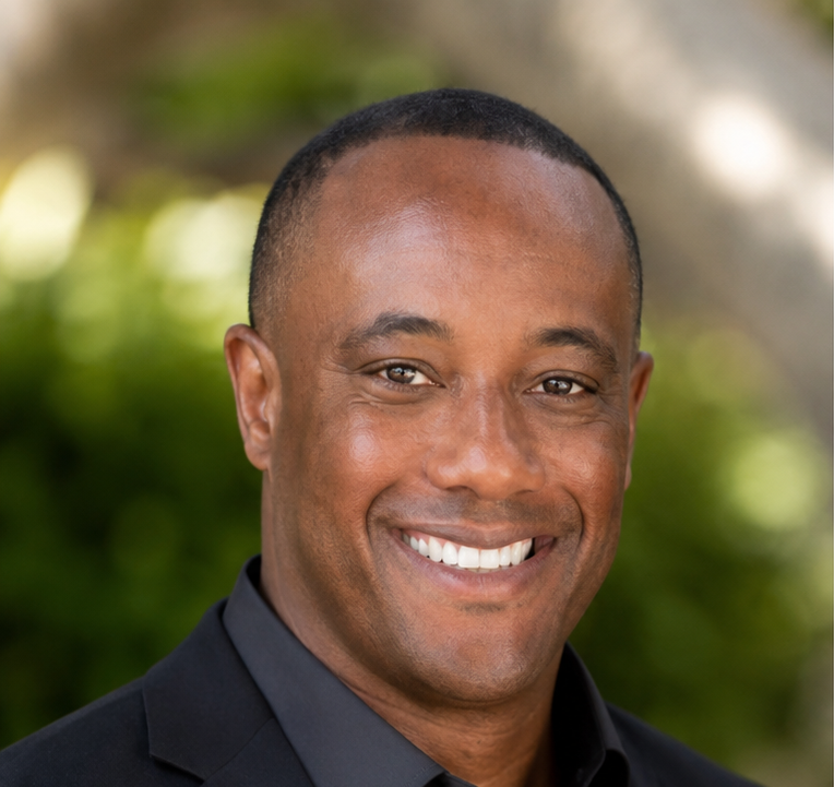 Charles Britt Jr. smiling outdoors
